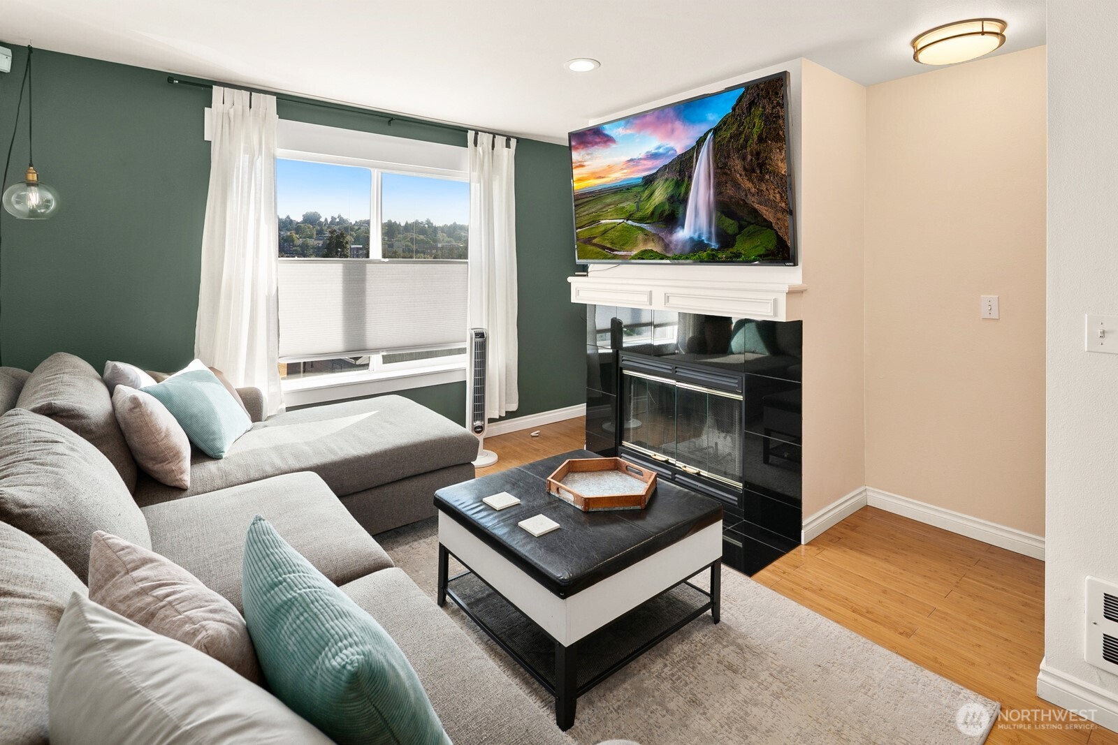 3224 21st Avenue West, Unit B Seattle, WA 98199 - Photo 3 of 17 a living room with furniture and a flat screen tv