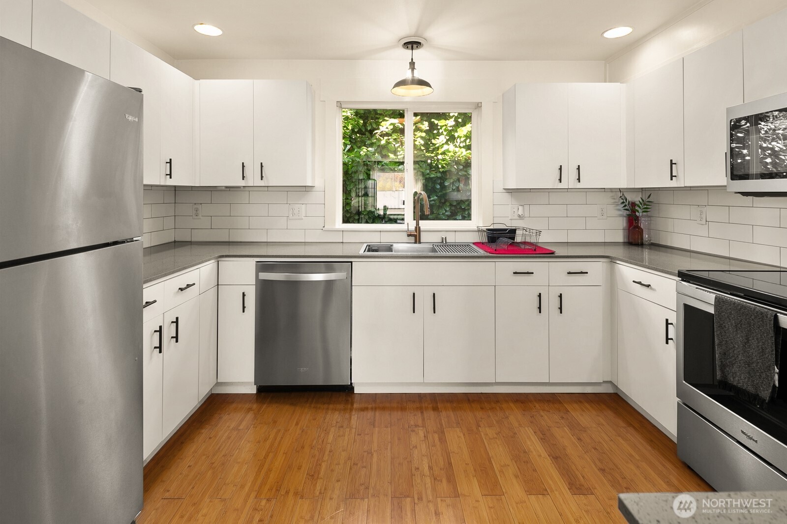 3224 21st Avenue West, Unit B Seattle, WA 98199 - Photo 8 of 17 a kitchen with a sink stove and refrigerator