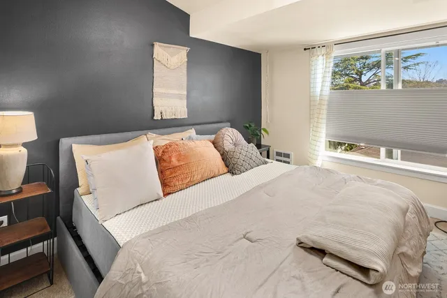 a bedroom with a bed and window