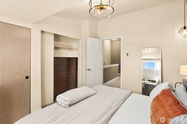 a bedroom with a bed and chandelier