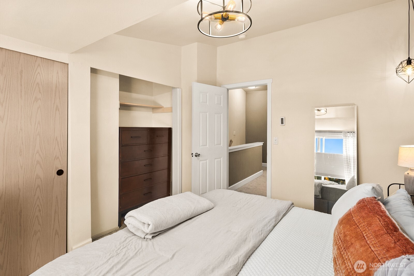 3224 21st Avenue West, Unit B Seattle, WA 98199 - Photo 10 of 17 a bedroom with a bed and chandelier