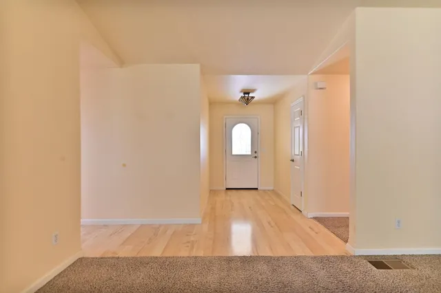 a view of a room with wooden floor