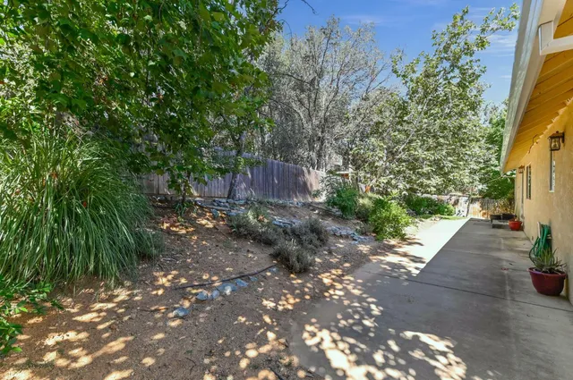 an aerial view of a houses with a lush green hillside