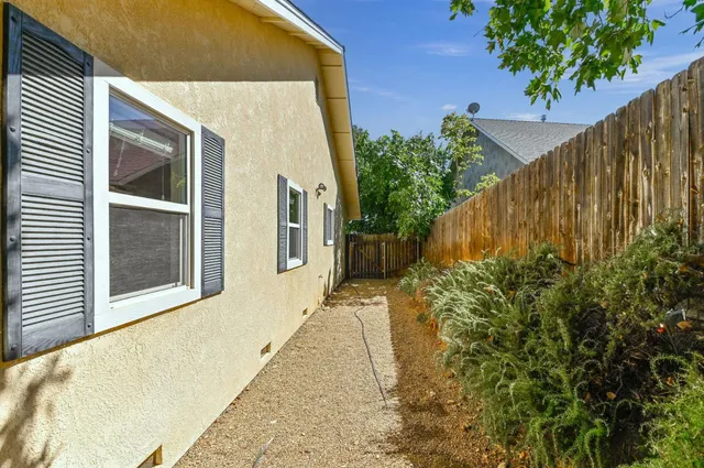 a front view of house with yard and trees around