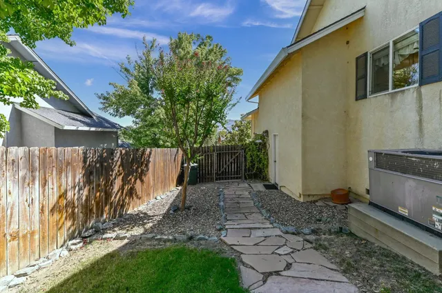 a front view of a house with a yard and outdoor seating
