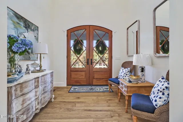 a living room with furniture wooden floor and window