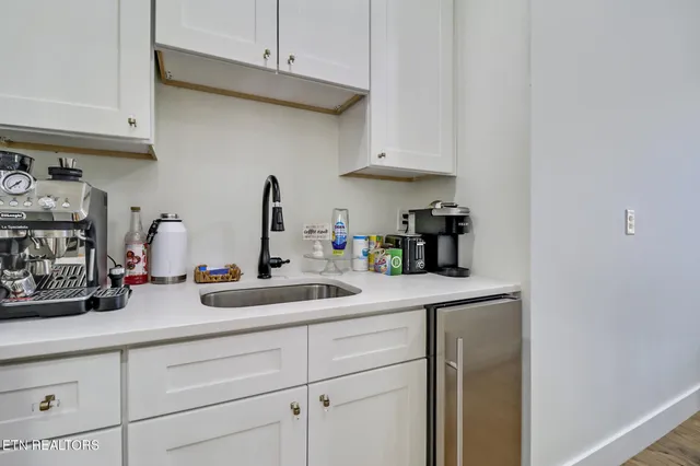 a bedroom with bed and a chandelier