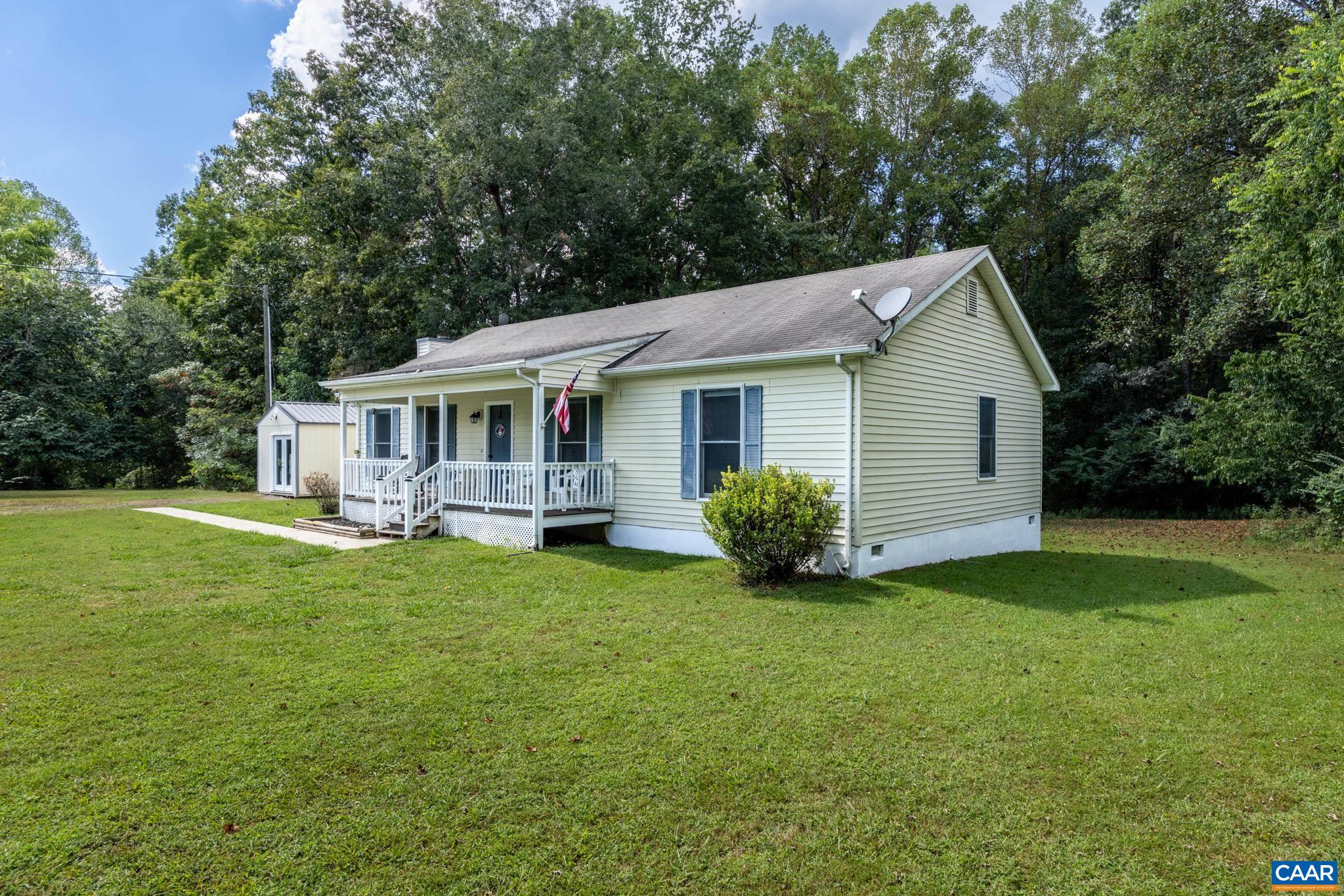 a view of a house with a yard and sitting area