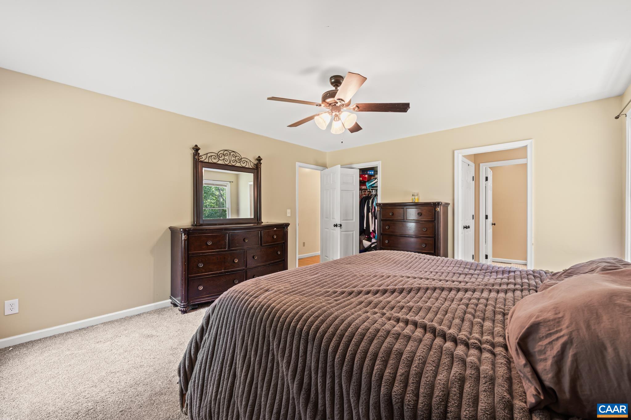 858 James River Road Scottsville, VA 24590 - Photo 14 of 33 a bedroom with a bed and dresser with mirror