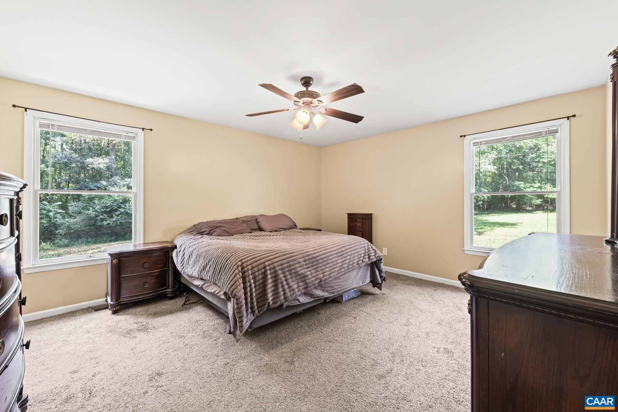 858 James River Road Scottsville, VA 24590 - Photo 15 of 33 a spacious bedroom with a bed and a window