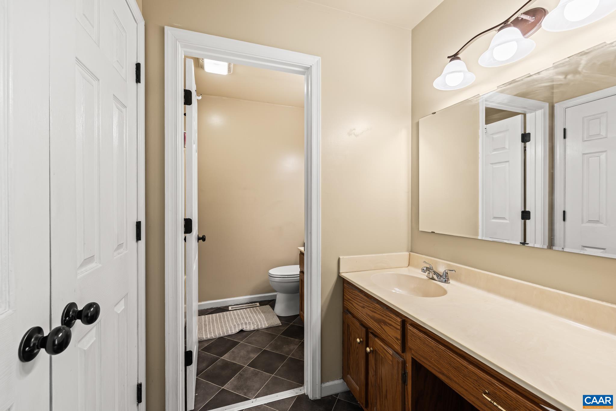 858 James River Road Scottsville, VA 24590 - Photo 16 of 33 a bathroom with a sink a toilet and shower