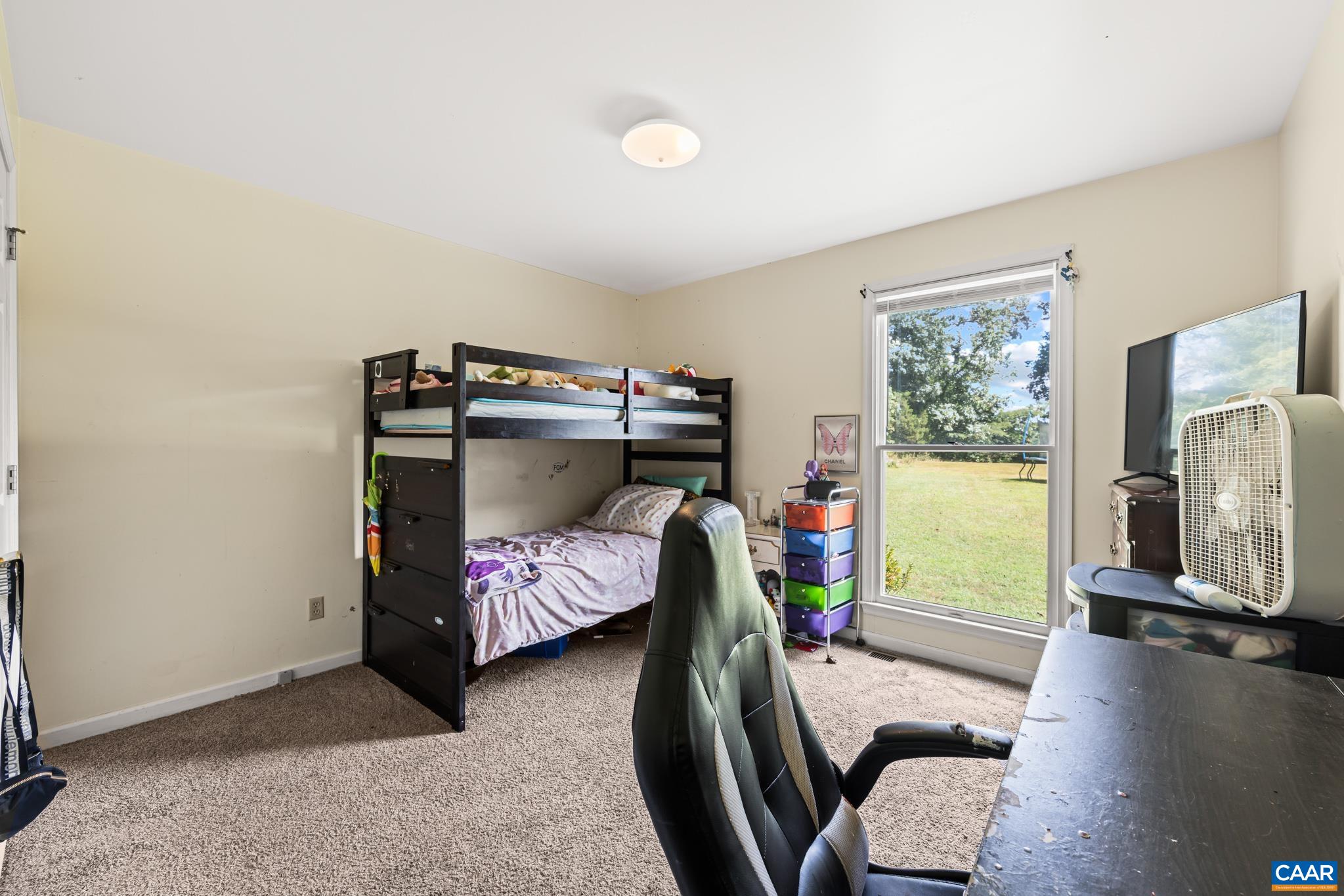 858 James River Road Scottsville, VA 24590 - Photo 20 of 33 a bedroom with furniture and a flat screen tv