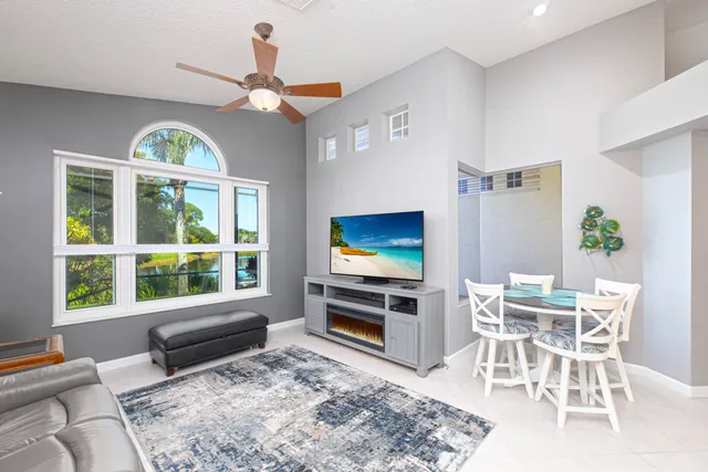 a living room with furniture a window and a flat screen tv
