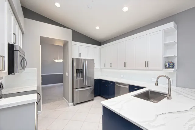 a kitchen with refrigerator cabinets and stainless steel appliances