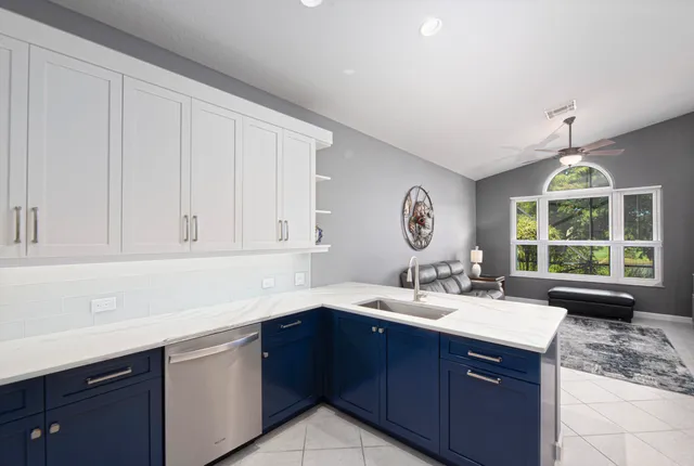 a kitchen with a sink window and cabinets