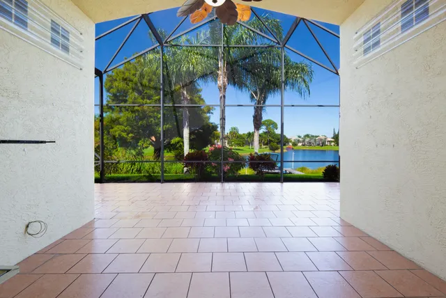 a view of a livingroom with a chandelier fan and windows