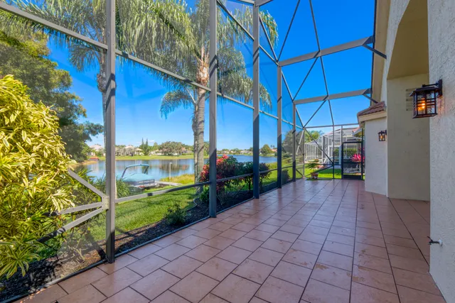 a view of backyard with a table and chair under an umbrella