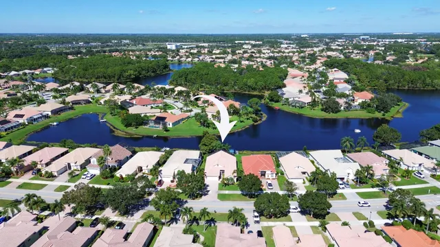 an aerial view of a house with a lake view