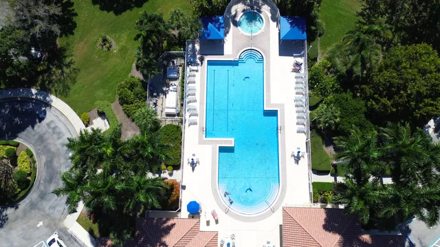 an aerial view of a house with pool outdoor seating and yard