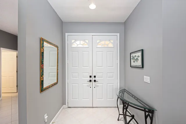 a view of a hallway with windows and cabinet