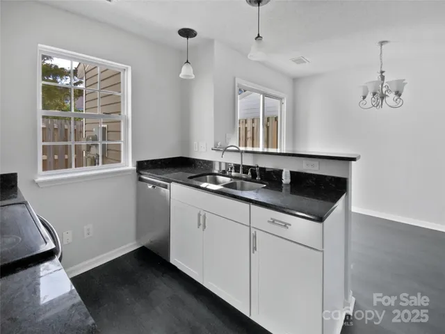 a kitchen with granite countertop a sink and a window