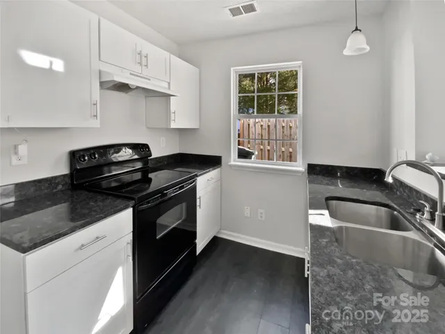 a kitchen that has a sink and a stove