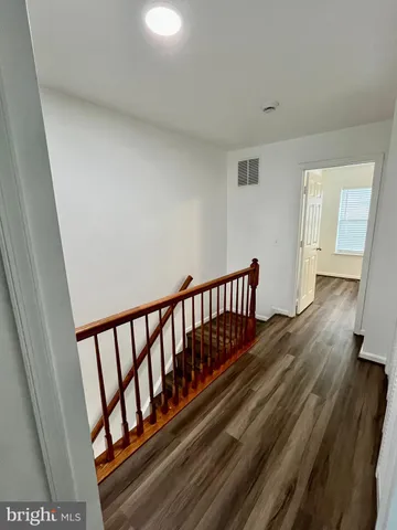 a view of hallway with wooden floor