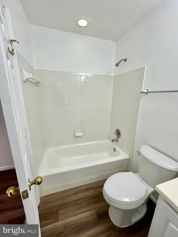 a bathroom with a toilet and a bath tub