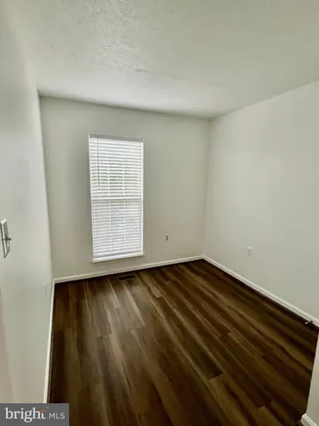 a view of an empty room and wooden floor