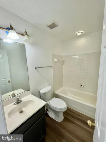 a bathroom with a sink toilet a mirror and shower
