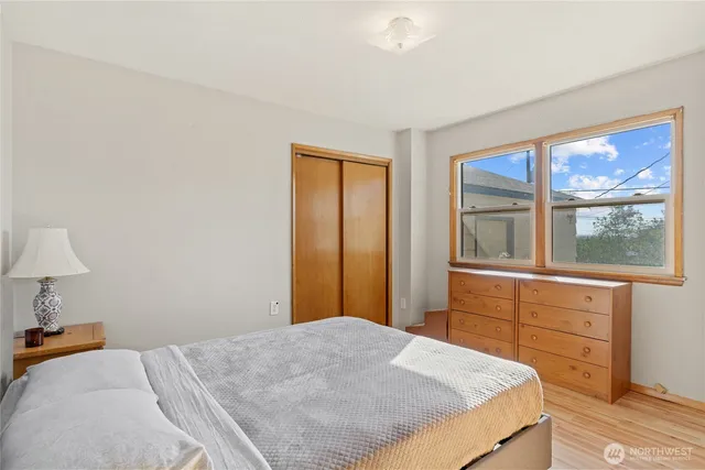 a bedroom with a bed and a window