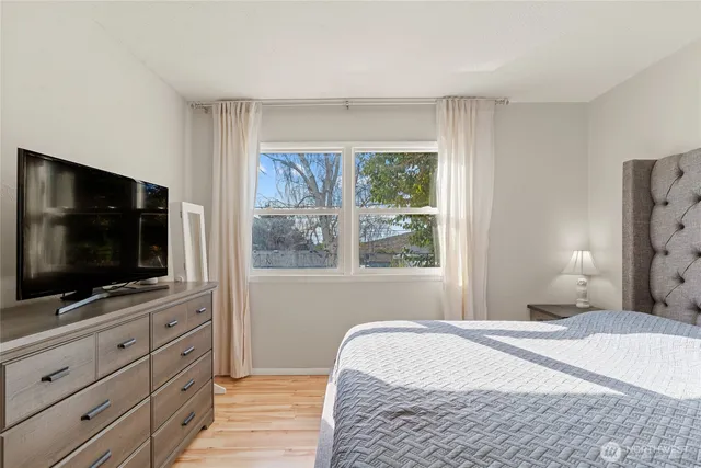 a bedroom with a bed and a flat screen tv