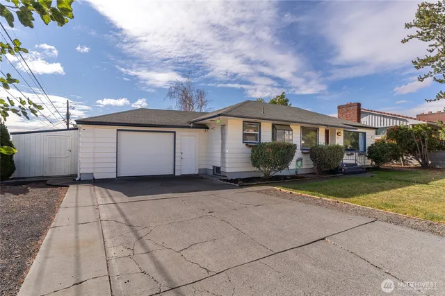 a view of a white house with a yard and large space