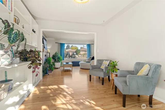 a living room with furniture and a potted plant