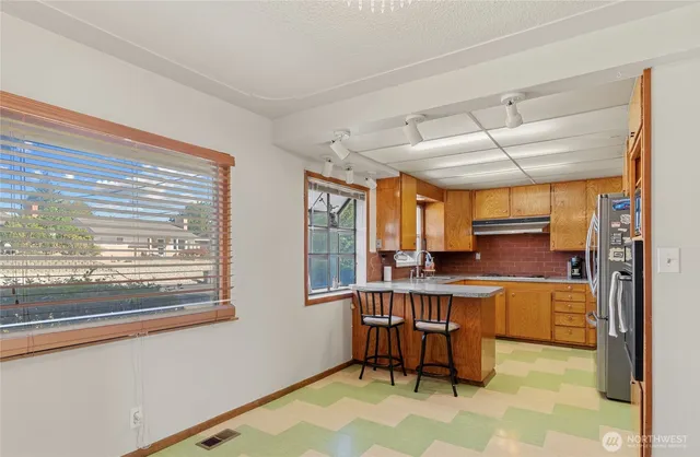 a view of a kitchen with a large window