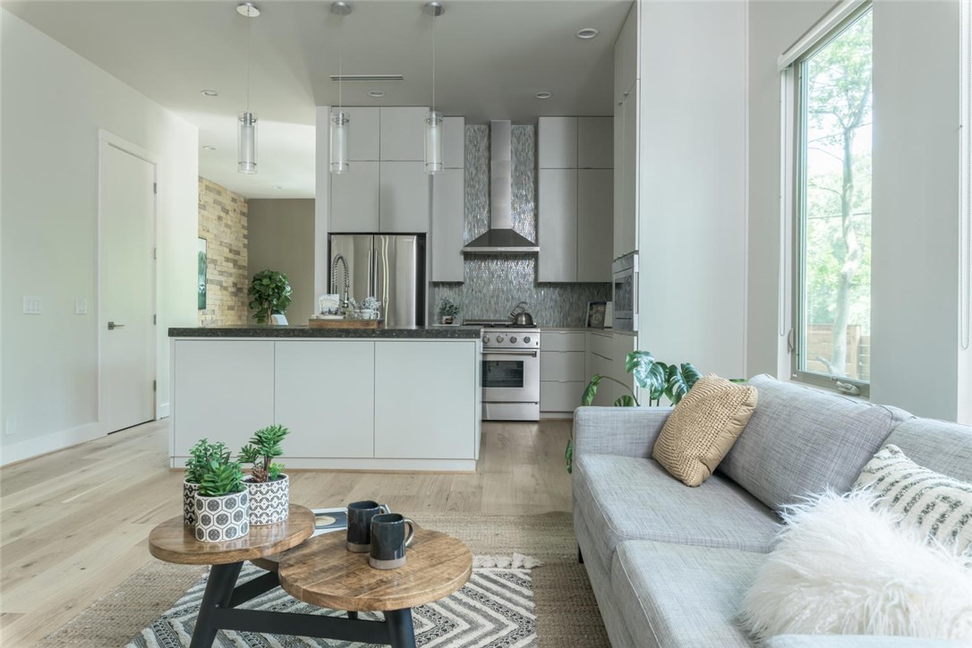 a living room with furniture and a potted plant