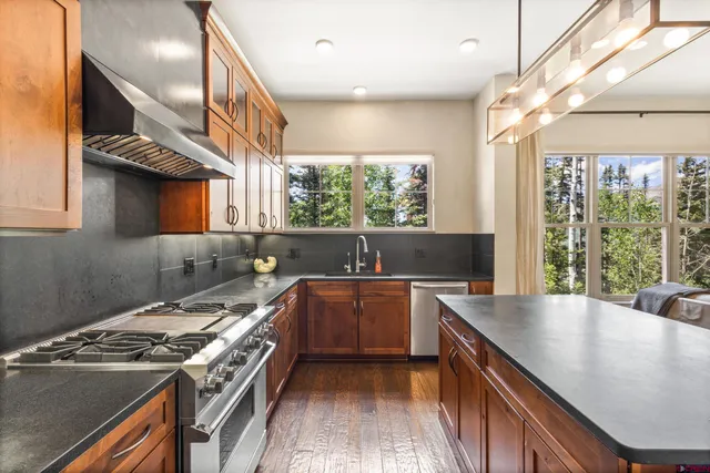 a kitchen with a stove a sink and a refrigerator