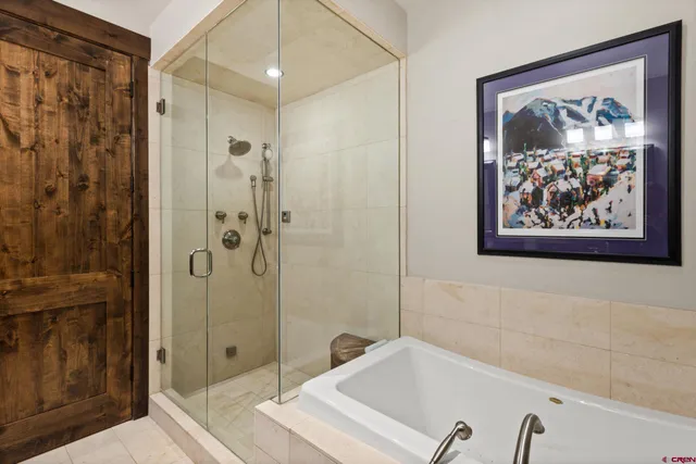 a bathroom with a tub and shower