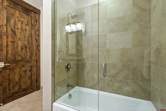 a bathroom with a shower and a sink
