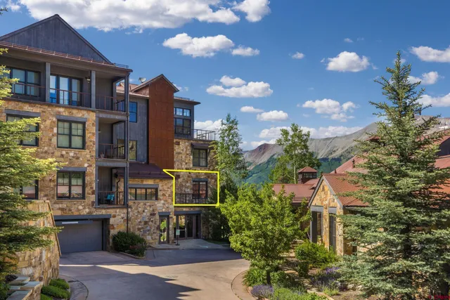 a front view of a residential apartment building with a yard