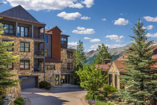 a front view of a residential apartment building with a yard