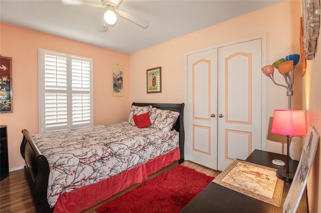 922 Hannah Way Dallas, TX 75253 - Photo 18 of 29 a bedroom with a bed and dresser with mirror