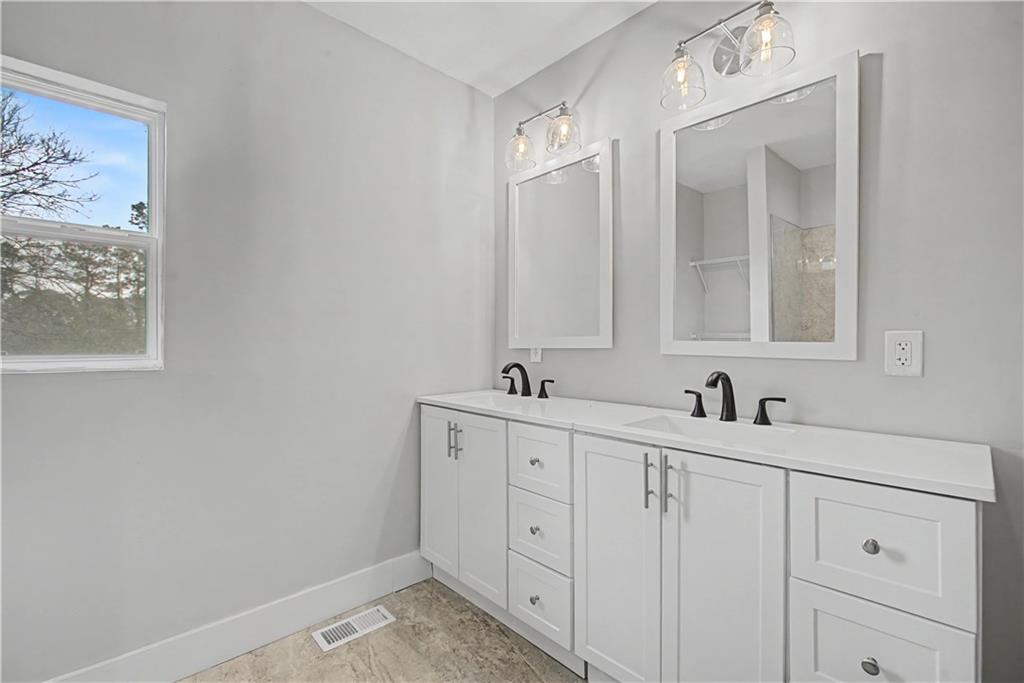 2835 Laguna Drive Decatur, GA 30032 - Photo 12 of 25 a bathroom with a sink and a mirror