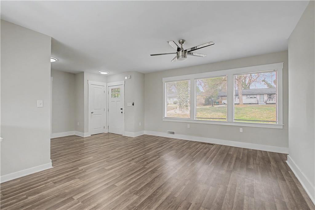 2835 Laguna Drive Decatur, GA 30032 - Photo 3 of 25 a view of an empty room with a window and wooden floor