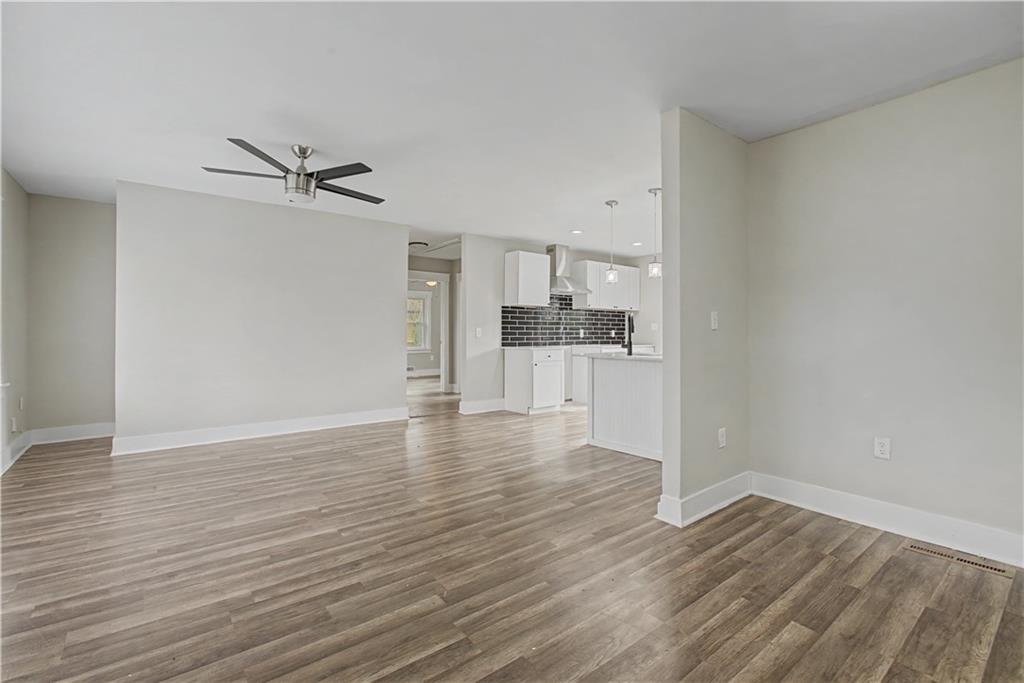 2835 Laguna Drive Decatur, GA 30032 - Photo 5 of 25 a view of a kitchen with wooden floor and a refrigerator