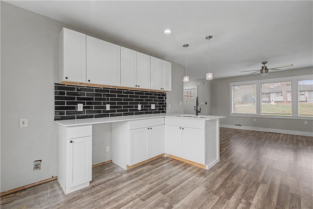 2835 Laguna Drive Decatur, GA 30032 - Photo 9 of 25 a kitchen with wooden floors and white cabinets