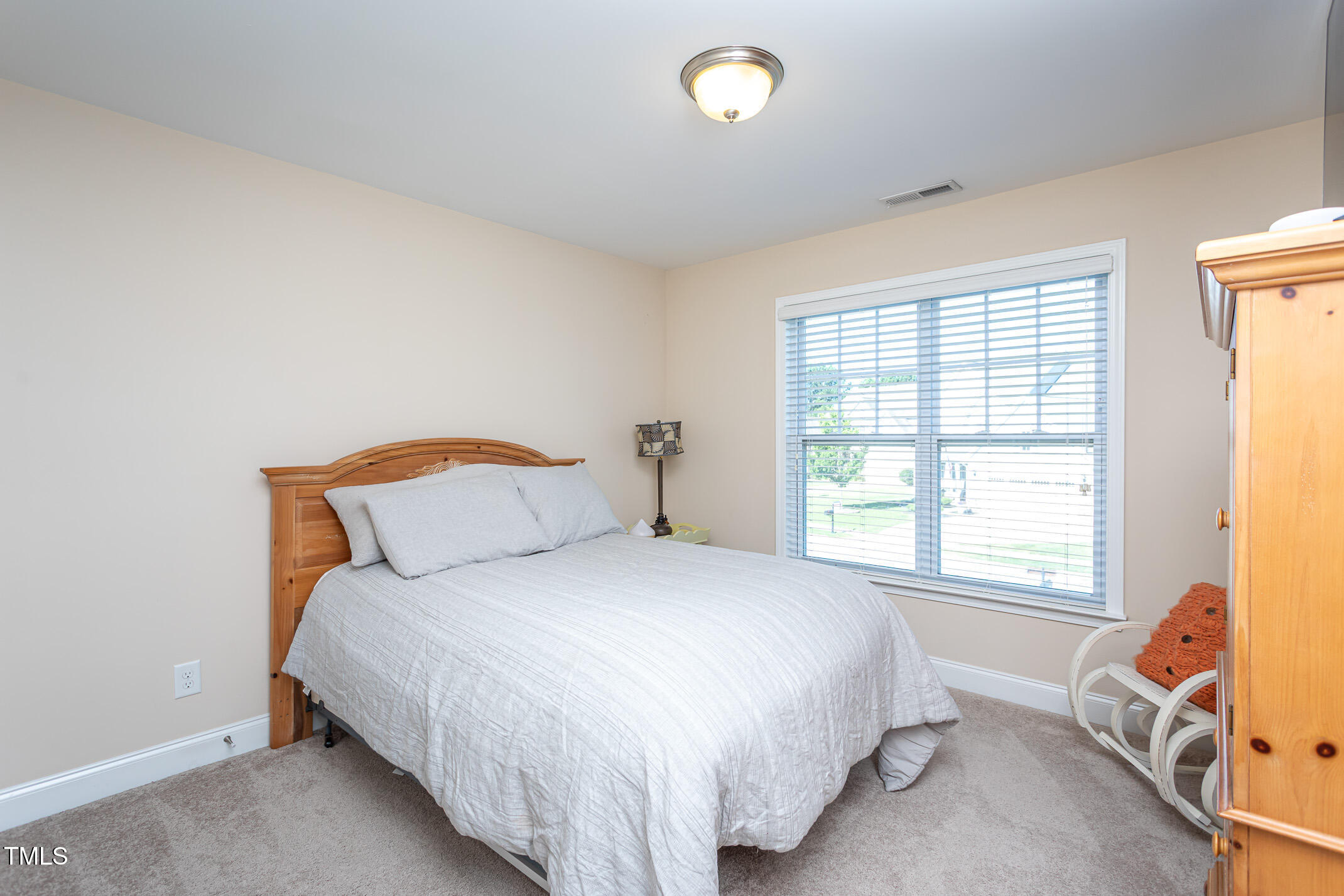 2411 Cattail Pond Drive Zebulon, NC 27597 - Photo 19 of 37 a bedroom with a bed and a window