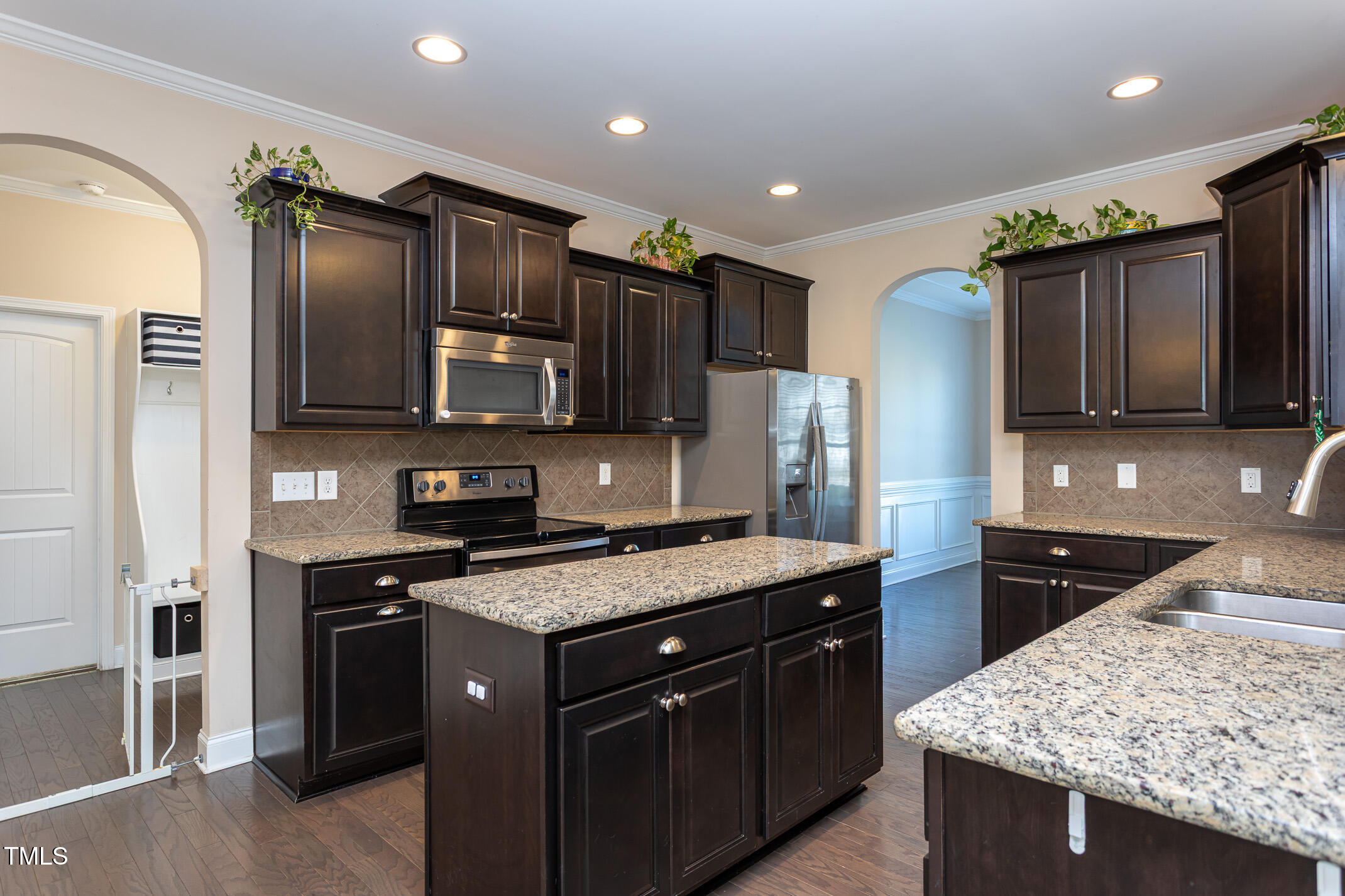 2411 Cattail Pond Drive Zebulon, NC 27597 - Photo 10 of 37 a kitchen with stainless steel appliances granite countertop a sink stove and refrigerator