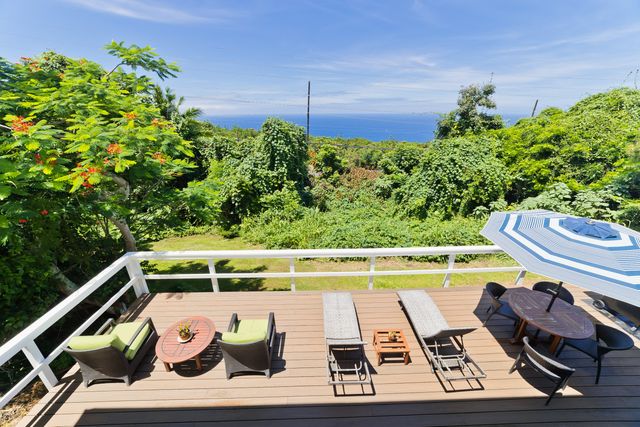a view of a two chairs in a balcony
