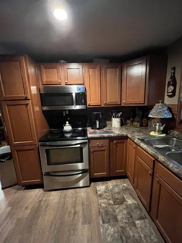 a kitchen with a sink stove and cabinets